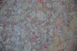 Distressed texture of the Kayseri carpet showing faded colors and exposed foundation.