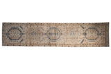 Distressed vintage Persian Karaja runner with large geometric medallions in navy blue and sand tones.