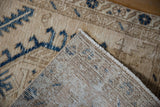 Folded corner of a Karaja rug showing the hand-knotted weave and low pile texture.