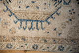 Even wear and textured knot heads on a vintage Karaja rug with navy blue geometric designs.