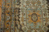 Distressed Malayer runner with rust, charcoal brown, and dusty blue geometric pattern detail.
