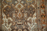 Distressed vintage Malayer rug pile reveals geometric animals, floral elements, and soft muted colors.