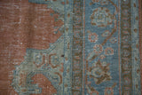 Distressed texture of vintage Khoy carpet with dusty orange and powder blue hues.