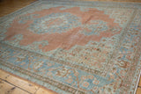 Worn Khoy carpet, dusty tangerine and powder blue patterns, with visible foundation.