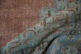 Distressed texture and pattern of vintage Khoy carpet in dusty tangerine, seafoam, and blue.