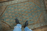 Distressed vintage Serbend rug with worn pile, abrashed aquatic blue ground, and faded copper boteh design.