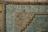 Stepped corner spandrel and meandering vine border of a distressed Serbend rug.