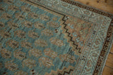 Distressed vintage Serbend rug corner, with stepped pale copper spandrel and blue field.