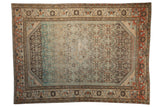 Distressed Borchalou rug with a Herati motif showing strong color abrash from charcoal to dusty blue with rose accents.