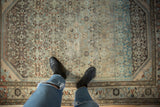 A close view of the even wear and low-pile texture on a distressed Borchalou rug with Herati motif.
