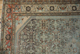 Artistically drawn vine border and worn Herati field on a vintage Borchalou rug corner.