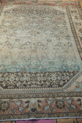 Low angle view across the distressed Borchalou rug showing its even, worn pile and soft abrash.
