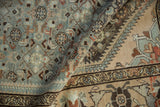 Even wear on a distressed Borchalou rug's dusty blue Herati field and contrasting tan border.
