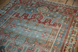Vintage Distressed Bakhtiari rug section featuring faded blue, red, and blush geometric floral vinery.