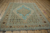 Distressed Bibikabad rug, faded powder blue diamond medallion, arrowed finial, sand Herati motifs.