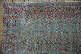 Textured detail of a vintage distressed Malayer rug with powder blue ground and cherry red Herati motif.
