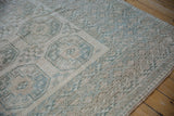 Vintage distressed Ersari rug, geometric gul medallion with serrated details, soft dusty teal and cream.