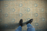 Evenly worn texture of a distressed Persian Hamadan rug showing its powder blue lattice design.