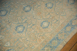 Evenly worn pile on a distressed Hamadan rug with sand, blue, and pale orange accents.