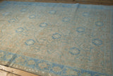 Low pile with even wear showing sand, sky blue, and pale orange tones on a distressed Hamadan.