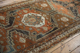 Distressed Malayer runner detail: tiered medallion, pinwheel florals, chestnut and oxidized silver.