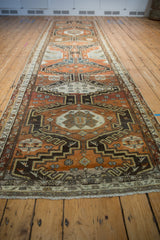 Distressed Vintage Malayer runner end with ivory fringe and floral cross-section border.