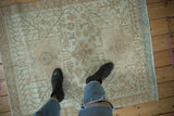 Distressed vintage Karaja rug with worn geometric patterns and faint foundation showing.