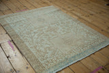 Corner detail of distressed vintage Karaja rug showing powder blue selvage and geometric motifs.
