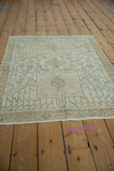 Vintage distressed Karaja rug with visible worn texture, geometric vinery, and powder blue blossoms.