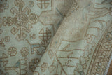 Textured distressed pile of the vintage Karaja rug in ivory, sand, and powder blue.