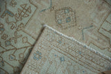 Vintage Karaja rug corner showing distressed ivory pile and hand-knotted back.