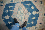 Distressed vintage Oushak rug with short pile in dusty cobalt and pale mauve.