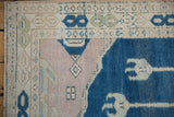 Vintage Oushak rug with stepped pale dusty mauve field and geometric border.