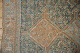 Distressed Qashqai rug with faded copper, teal patterns and visible low pile.