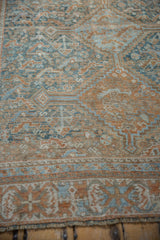 Distressed Qashqai rug with even wear showing geometric patterns in pale teal and copper.