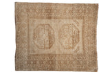 Distressed vintage Ersari square rug with double gul medallions, geometric borders, and abrashed beige tones.