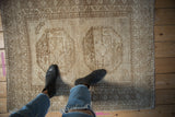 Vintage distressed Ersari rug featuring double gul design, even wear, and muted beige tones.