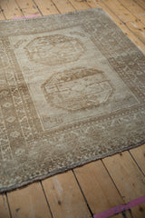 Distressed vintage Ersari rug with an abrashed field and multi-layered neutral borders.