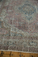 Close-up of distressed traditional Sparta rug, showing worn texture and faded floral patterns.