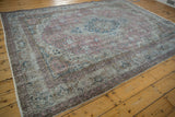 Faded floral motifs in dusty raspberry and navy on the distressed Sparta rug.