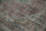 Low pile of vintage Sparta rug with visible foundation, faded dusty raspberry and navy patterns.