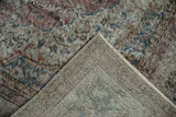 Pile wear, muted palette, and foundation weave on a folded Sparta rug corner.