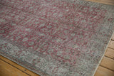 Distressed vintage Sparta carpet with faded cochineal red and silver floral vinery, showing foundation wear.