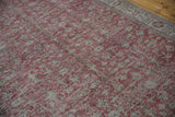 Distressed overdyed texture of a Turkish Sparta carpet with faded dusty cochineal red and silver.