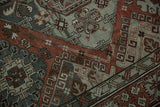 Detail of the hand-woven texture showing floral and hook-and-latch motifs in chestnut and slate blue.