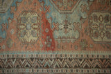 Distressed Soumac carpet detail with geometric medallions, reciprocating border, and abrashes.