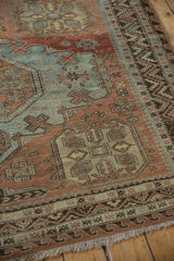 Distressed vintage Soumac carpet detail, dusty powder blue motifs and wave border.