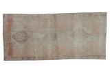 Distressed Oushak runner rug with triple medallions and geometric pattern in muted ivory and blush.
