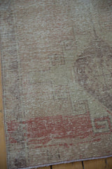Distressed vintage Oushak runner texture, with visible ivory foundation and ruby red tones.