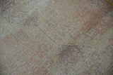 Distressed Oushak rug runner, textured surface revealing worn knot heads and muted patterns.
